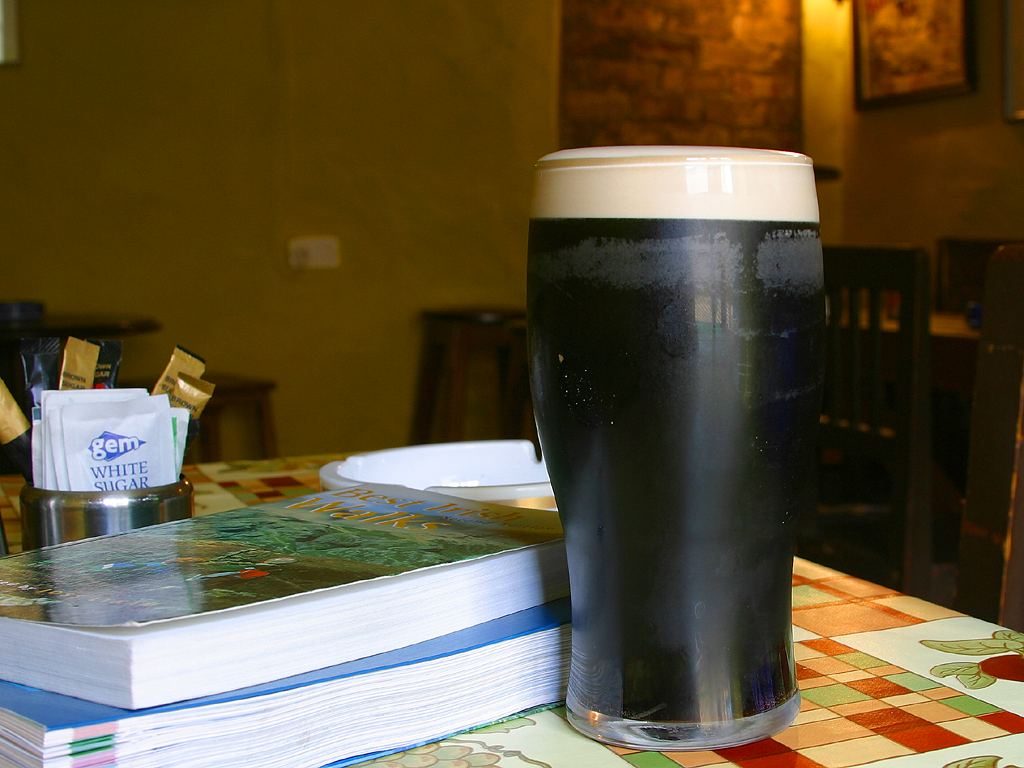 A pint of Guinness on a pub table