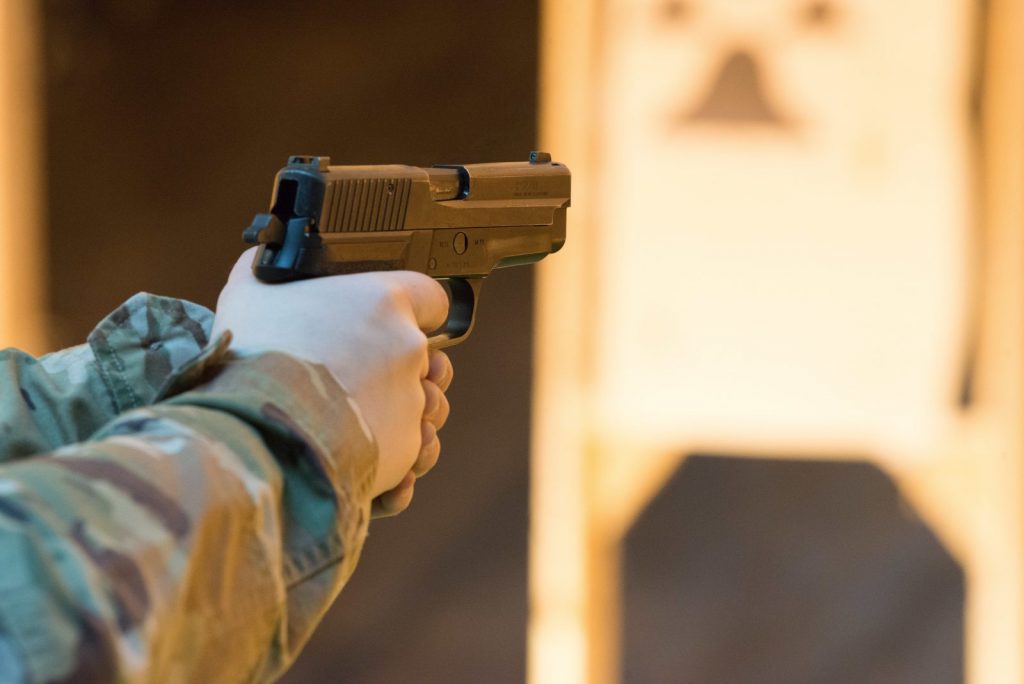 Firing a pistol at a shooting range